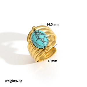 Detail view of vintage stainless steel ring showing 14.5mm green stone and wavy golden band