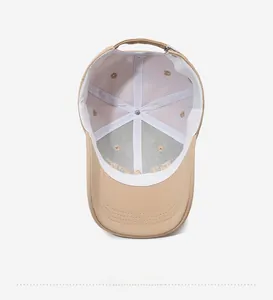 Detailed interior of khaki baseball cap featuring reinforced white lining and ventilation holes