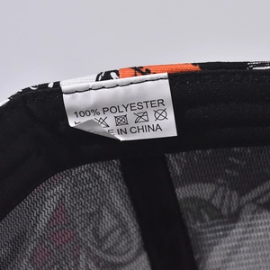 Detailed view of the wash care label showing 100% polyester fabric on a baseball cap