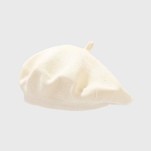 Detailed close-up of cream knit beret showing fine cotton texture and top stem detail