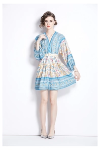 Detail of ethnic print V-neck dress with lantern sleeves and belted waist in light blue