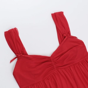 Macro view of red mesh camisole featuring front pleated details and bow shoulder straps