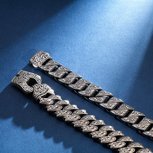 Vintage stainless steel punk rocker bracelet with intricate floral engravings and snap clasp