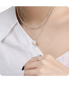 Close-up of double layer S925 silver necklace with pearl pendant and matching ring
