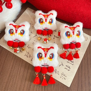 Detailed embroidery of Chinese New Year lion dance hair clip with red silk tassels and bells