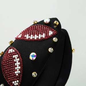 Knotted headband with rugby ball beadwork and rhinestones on black padded fabric