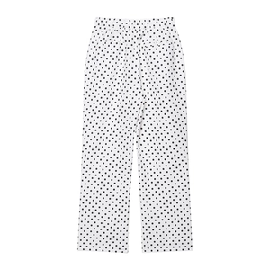 Détail à plat d'un pantalon noir et blanc à pois avec taille élastiquée