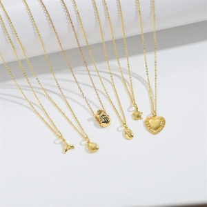Golden O-chain necklace set with money bag and turtle pendants on white background