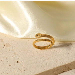 Macro detail of 18K gold-plated snake ring with intricate scale texture and open design