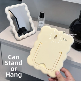 Detail of the foldable stand and wall-mounting hole on the cream wave makeup mirror
