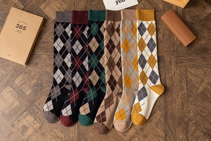 Classic argyle knit high socks in six vintage colors displayed on a rustic wood surface