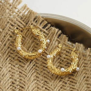 18k gold plated chunky hoop earrings with pearls and rhinestones on a metal tray