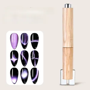 Close-up of detachable wooden nail magnet tool showing cat eye effect on nail tips