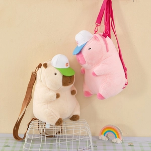 Plush Capybara and pink pig backpacks with cute hats displayed in a cozy setting