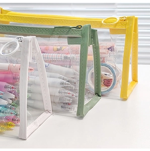 Detailed view of colorful transparent triangular PVC stationery bags in yellow, green and white