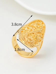 Detailed macro view of gold-plated hollow floral ring with intricate woven pattern