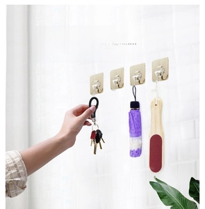 Strong adhesive stainless steel J-hook hooks mounted on white tiles for home organization