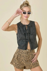Close-up of dark grey washed denim vest featuring triple bow tie-up front fasteners