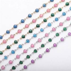 Detail of colorful glitter heart charms on 18K gold and silver plated stainless steel chains