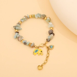 Detail of beaded bracelet with natural stones and gold elephant enamel charm