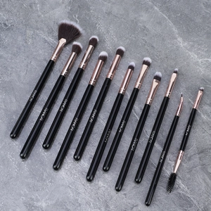 Detail view of 12pcs black and rose gold makeup brushes with RANCAI logo on marble