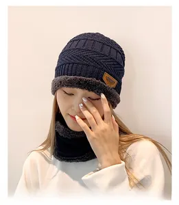 Detail of navy knit beanie and neck warmer set with thick grey plush fleece lining