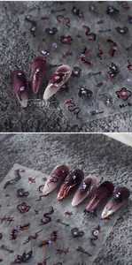 Macro detail of dark Gothic nail art stickers featuring purple hearts and thorns