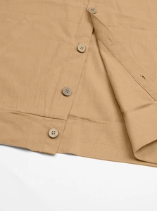 Close-up of khaki cotton linen shirt showing fabric texture and vintage buttons detail