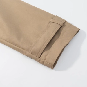 Detailed close-up of khaki trench coat cuffs showing high-quality twill cotton texture