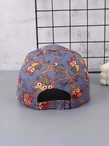 Close-up of owl print baseball cap showing rear adjustable metal buckle and blue canvas fabric