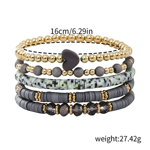 Detail of 5-piece bohemian beaded bracelet set with grey polymer clay and heart charm