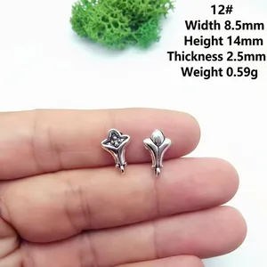 Macro shot showing dimensions of silver vintage flower bud alloy charms for jewelry