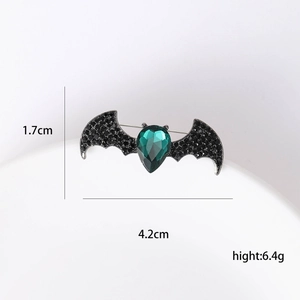 Gothic bat brooch in dark alloy with green gemstone and black rhinestones, 4.2cm width