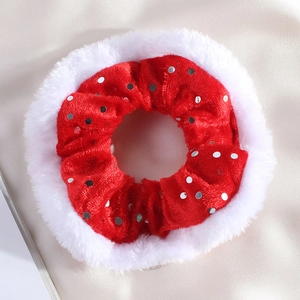 Detail of red velvet Christmas scrunchie with white plush trim and silver sequins