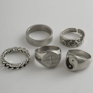 Close-up of five silver rings featuring Tai Chi and Star patterns in hip-hop style