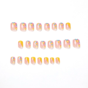 Faux ongles adhésifs avec pointes French jaunes et motifs floraux colorés