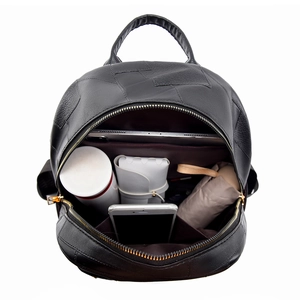 Top view of open black backpack showing spacious interior with laptop and daily essentials