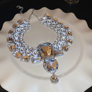 Macro shot of silver statement necklace with crystal heart and teardrop pendants