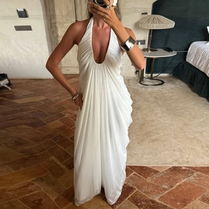 Detail view of white backless halter dress with deep V-neck and elegant pleats