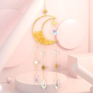 Close-up of golden moon suncatcher featuring yellow crystal stones and metal sun charms