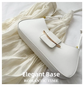 Close-up of a white leather hobo bag featuring a crescent-shaped gold metal buckle