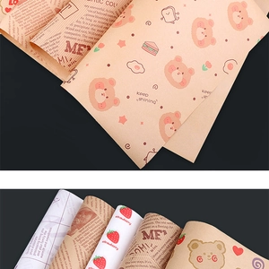 Close-up of greaseproof sandwich wrapping paper with various printed bear and food patterns