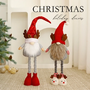 Pair of Christmas gnome plush decors with sequin hats and long legs on a festive background