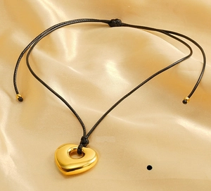Macro view of polished 3D heart pendant on black cord made of eco-friendly stainless steel