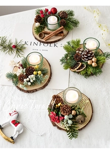 Detail of Christmas candle holders with pine cones, cinnamon sticks, and LED candles