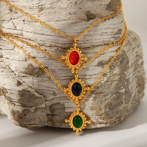 Three gold stainless steel layered necklaces with red green black gemstone cross pendants