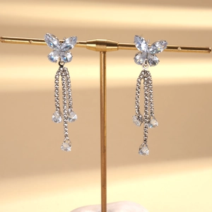 Macro shot of silver zircon butterfly pendant with long sparkling tassel droplets