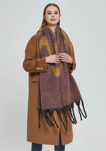 Detailed view of the wave pattern jacquard texture and thick black woven tassels on scarf