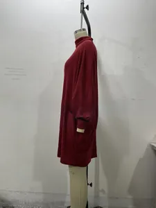 Detail of burgundy ribbed knit turtleneck dress with long sleeves and loose fit style