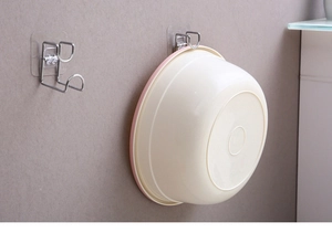 Close-up of wall-mounted stainless steel hook with adhesive backing for basins